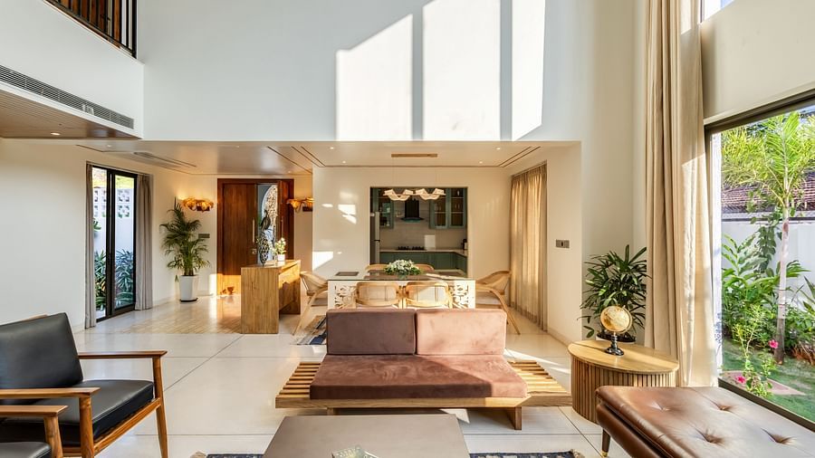 A stylish living area with a minimalist design, ample sunlight, and an open layout connecting to the outdoors - BluSalzz Villas - Alocassia, Anjuna