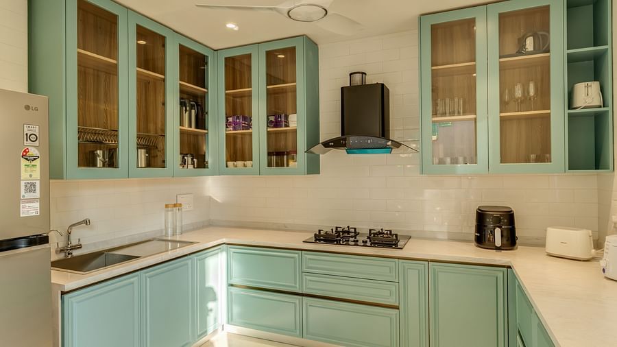 A sleek kitchen with pastel-coloured cabinets, integrated appliances, and a bright, airy ambience.