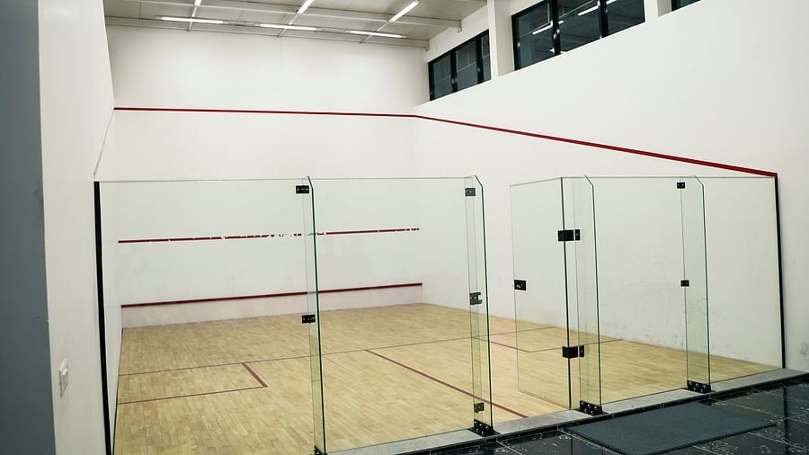 Another indoor squash court at BNGV Grandeur Hotel and Banquets, featuring glass walls and a well-maintained court.