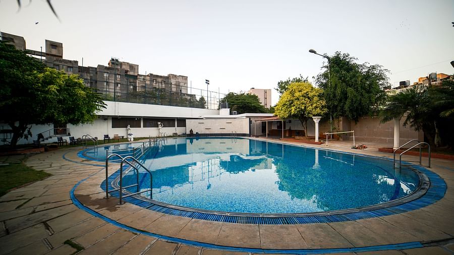 Another view of the outdoor swimming pool at BNGV Grandeur Hotel and Banquets, showing its shape and surrounding deck.