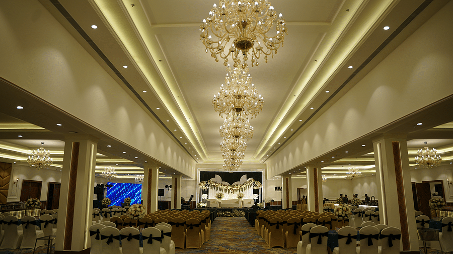 Grand banquet hall at Brij Eternity, Vrindavan  | An elegant, well-lit banquet hall with luxurious chandeliers and a spacious seating arrangement