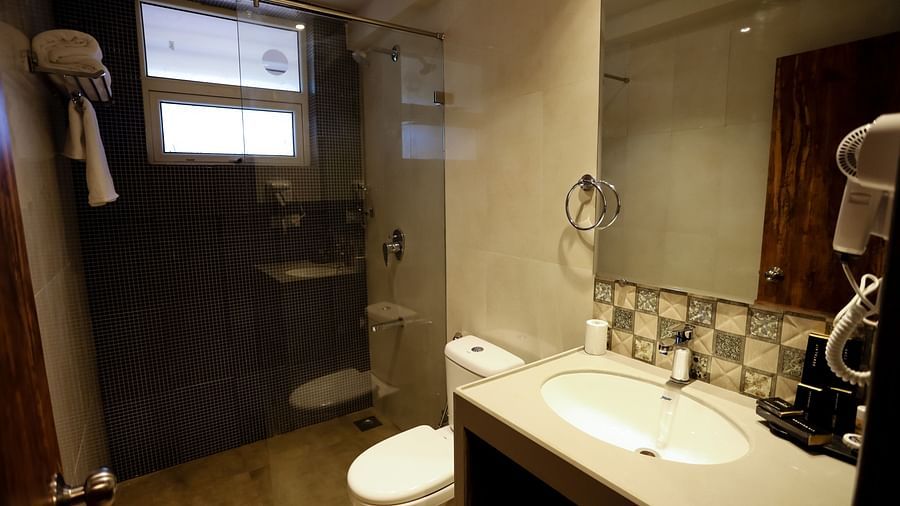 Image of a washroom with a sink and a toilet on the side at Calux Grand Baga.
