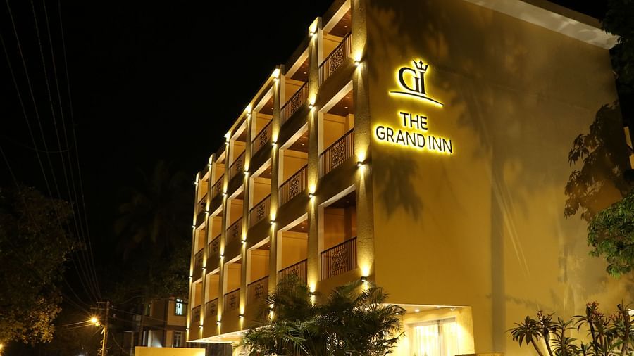 Night view of Calux Grand Inn, Calangute facade with The Grand Inn written on it.
