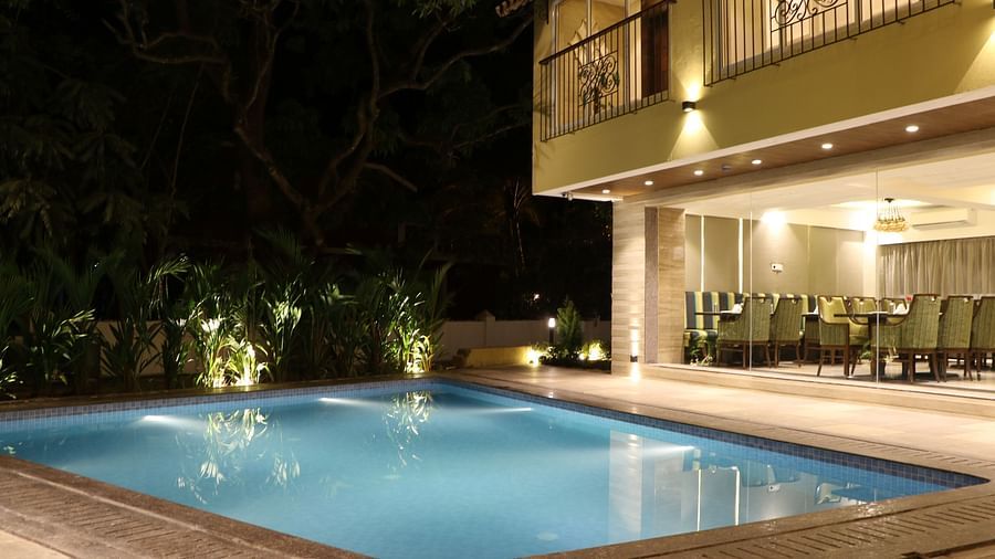 Night view image of a swimming pool in front of Calux Grand Inn, Calangute.