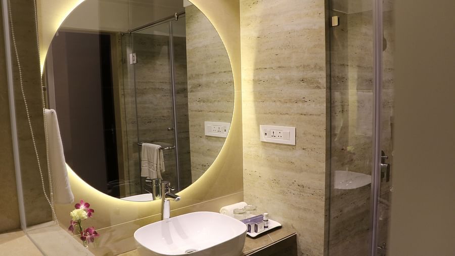 Image of a sink with a mirror above it at Calux Grand Inn, Calangute.