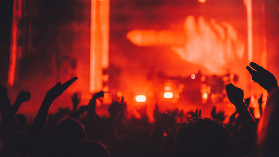 People grooving to the music in a party with LED lights illuminating the area