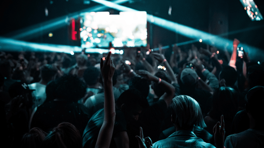 a group of people dancing in a concert