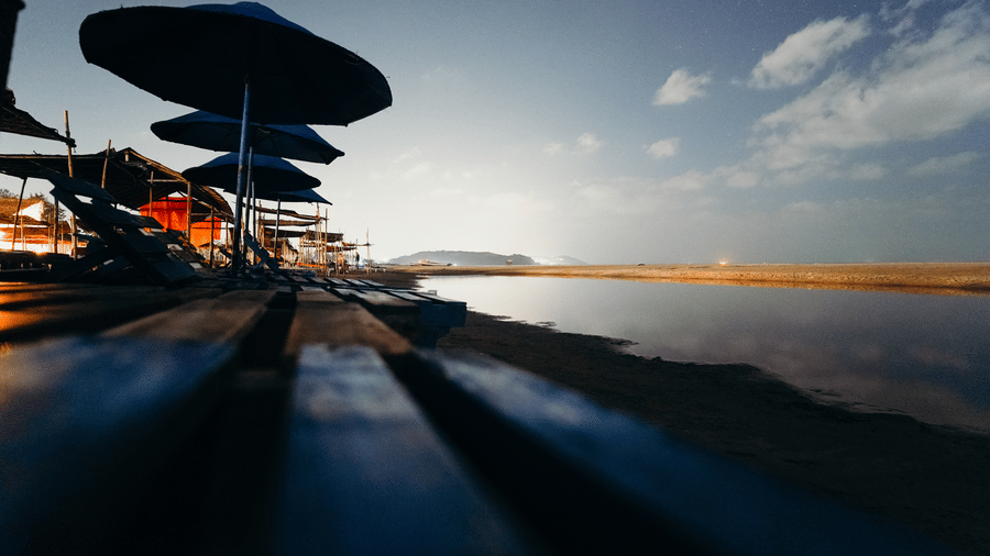 a view from the wooden boards on the floor of umbrellas and shacks