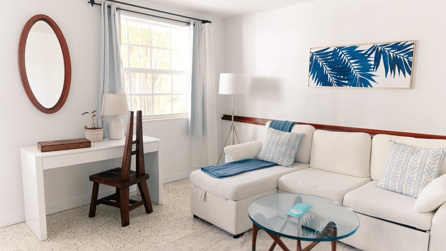 Bright living area with cozy seating, coastal artwork, and natural light at Casa Morada.