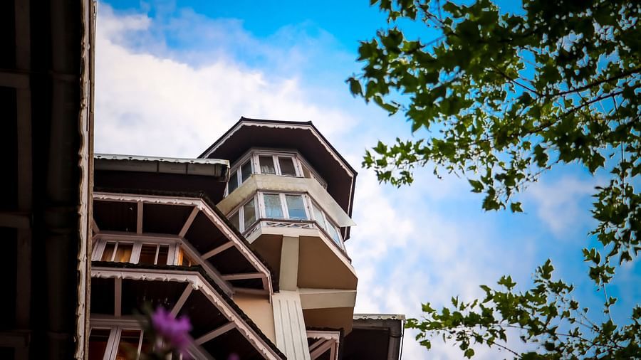 Upward view of Cedar Inn exterior against blue sky