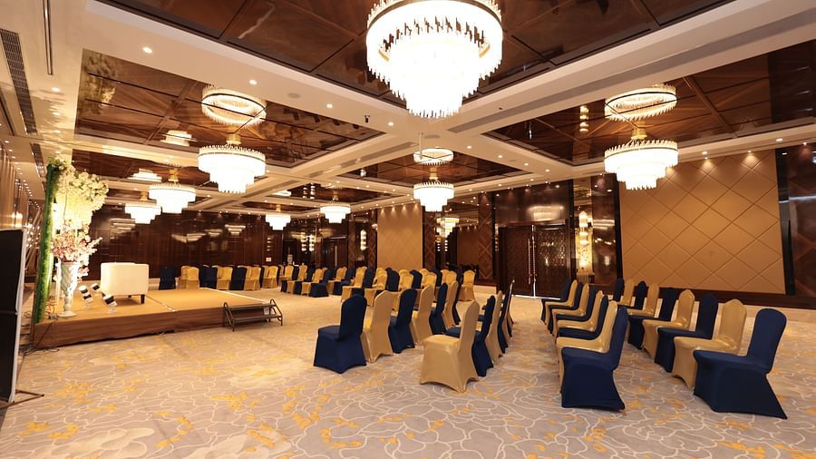 A side view of a banquet hall with chairs arranged around the stage area | Cenneys Gateway