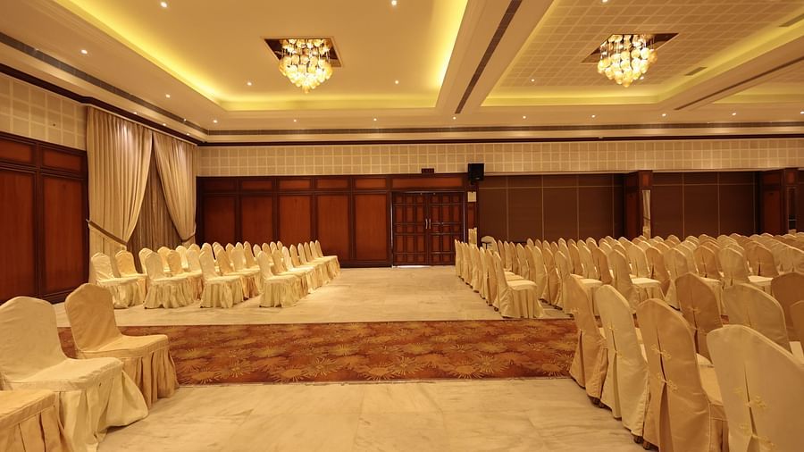 A side view of the banquet hall with neatly arranged decorated chairs | Cenneys Gateway