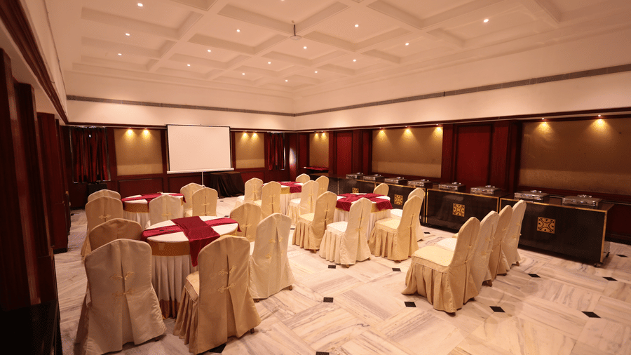 A banquet hall view from behind, with decorated tables and chairs at Cenneys Gateway.