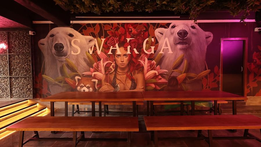 A large wooden table with seating in front of a postered wall | Cenneys Gateway