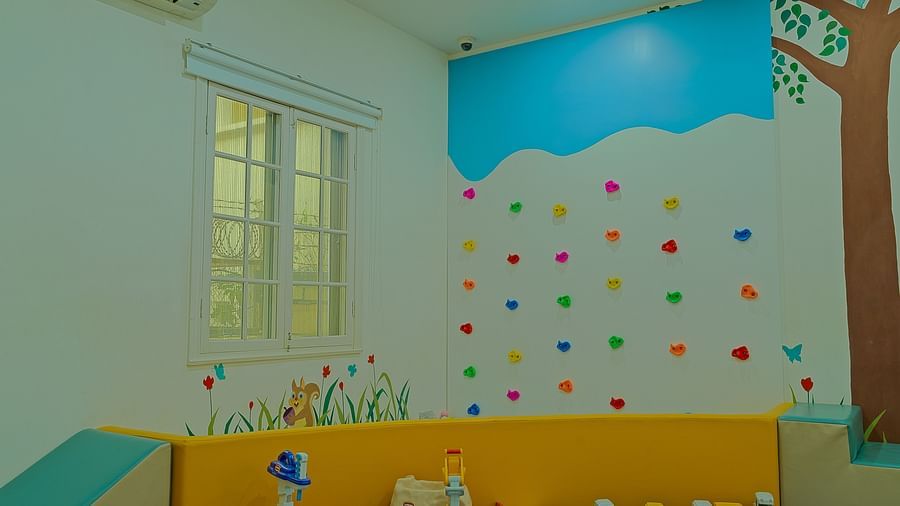 A brightly coloured playroom with cartoon-like decorations and a play area | Central Mansions, Phnom Penh