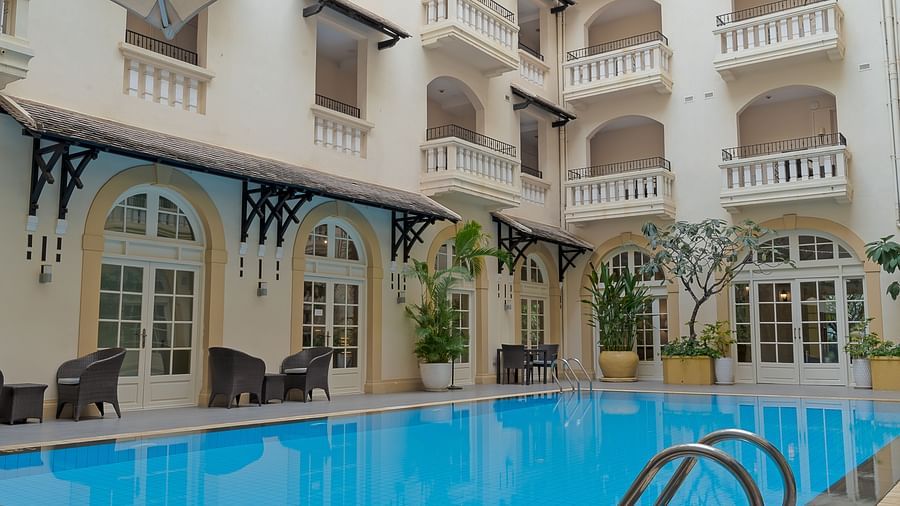 An exterior view of a building with a swimming pool | Central Mansions, Phnom Penh