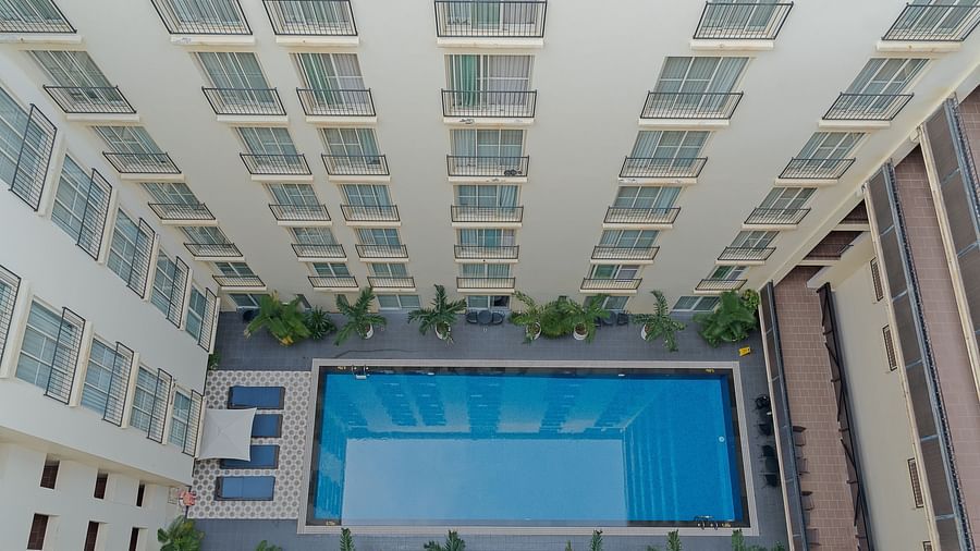 An aerial view of a building with a swimming pool in the courtyard | Central Mansions, Phnom Penh