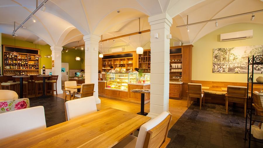 A view of an interior of a restaurant with tables and chairs | The Shop | Central Mansions, Phnom Penh