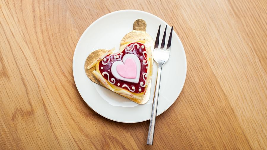 A heart-shaped cookie with a fork on a wooden table | The Shop | Central Mansions, Phnom Penh