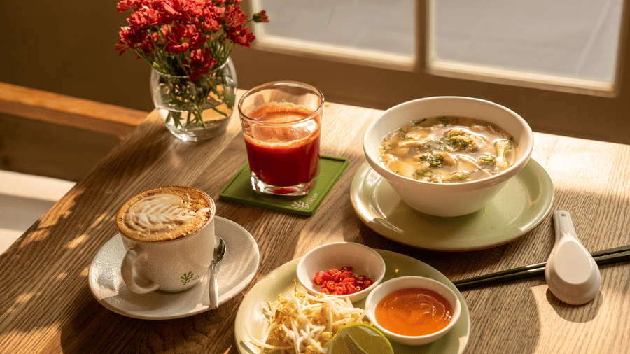 Breakfast spread featuring yoghurt, pastries, fruit, coffee, and fresh juice at Central Mansions, Phnom Penh.