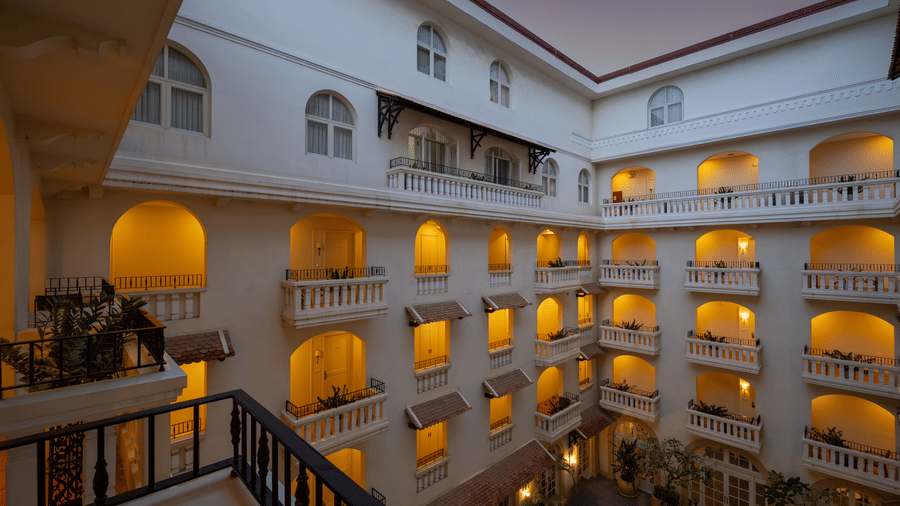 Interior courtyard with arched balconies and illuminated windows at Central Mansions, Phnom Penh.