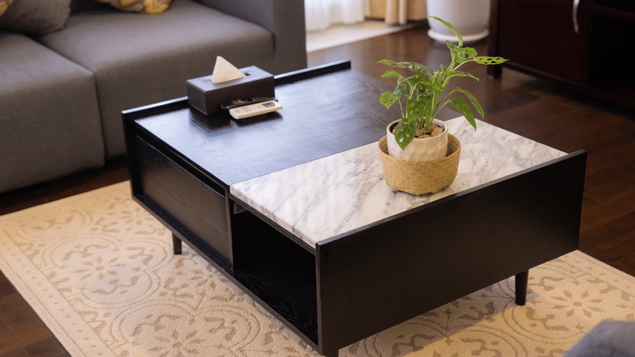 Living room with a coffee table, sofa, and decorative furnishings at Central Mansions, Phnom Penh.