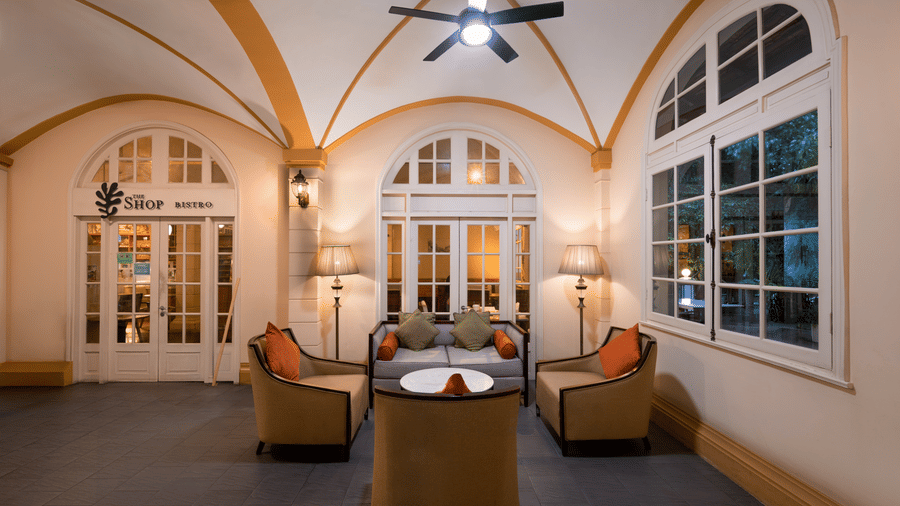 Lounge area with arched ceilings, comfortable seating, and large windows at Central Mansions, Phnom Penh.