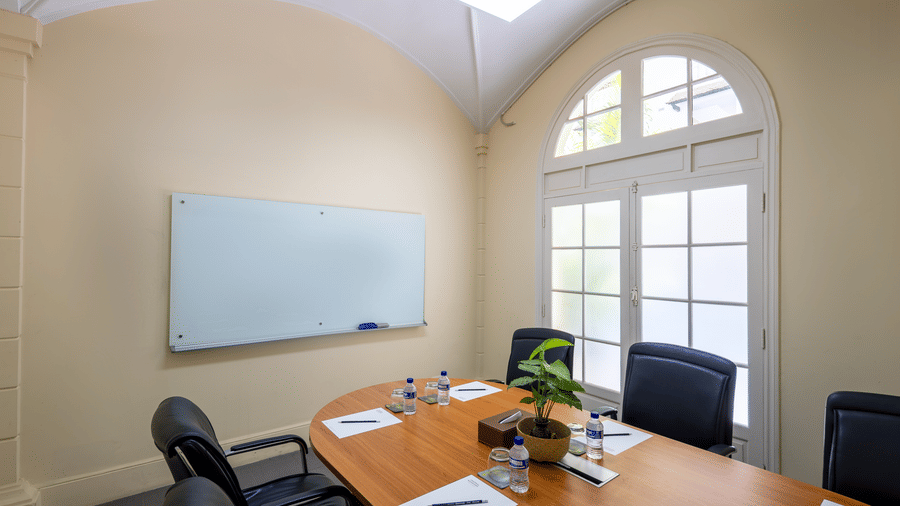 Meeting room with a conference table, chairs, and wall mounted display at Central Mansions, Phnom Penh.