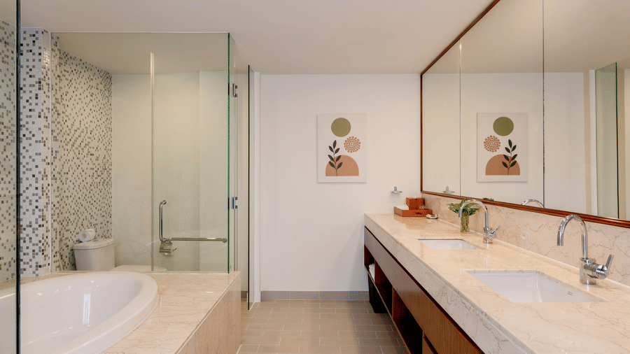 Spacious Penthouse bathroom at Central Mansions, Phnom Penh with a double vanity, bathtub, walk in shower, and premium fittings.