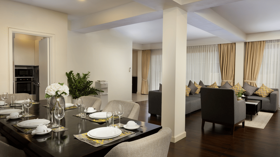 Dining and living area of the Penthouse at Central Mansions, Phnom Penh with a dining table, seating area, and open layout.