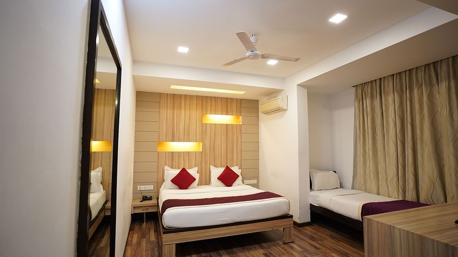 an image of a executive deluxe room with a long mirror at  City Centre Residency, Bangalore