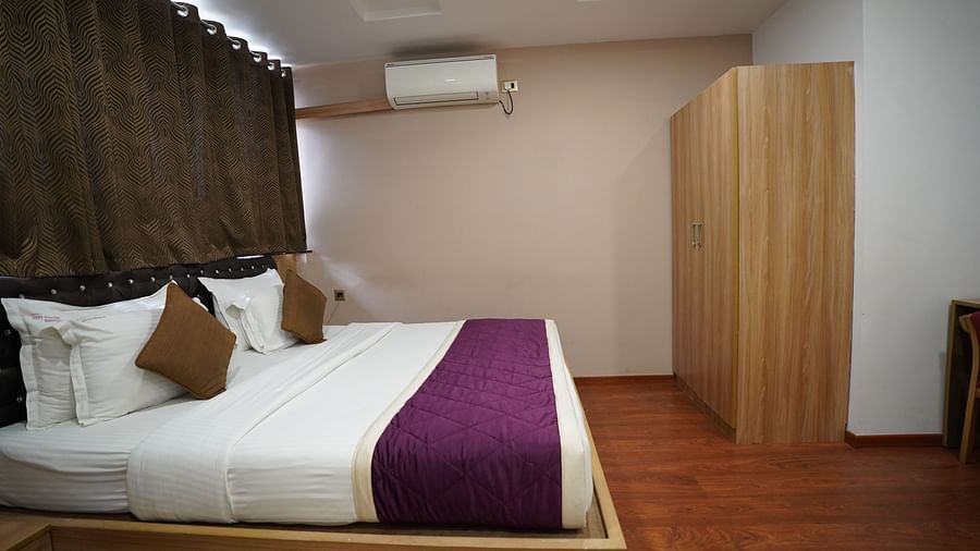 an image of side view of deluxe room with a wardrobe