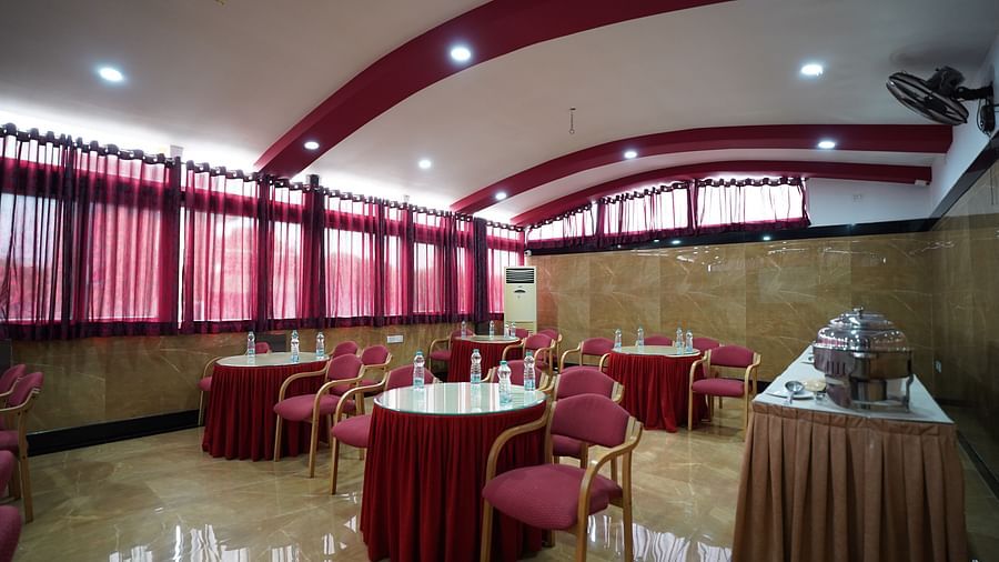 an image of an event hall with round tables and chairs 