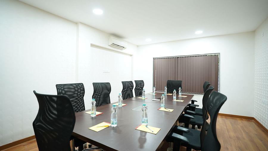 an image of a boardroom with a long wooden table and chairs at  City Centre Residency, Bangalore