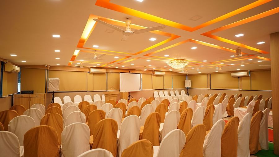 an image of a event hall with designed ceiling illuminating orange lights at  City Centre Residency, Bangalore