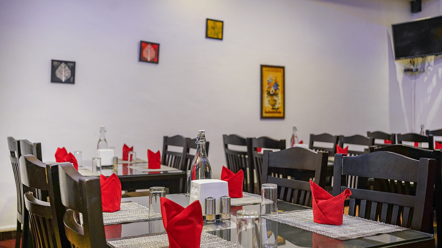 Image of a dining space with napkins placed on the table at Coorg Jungle Camp Backwater Resort, Kushalnagar.