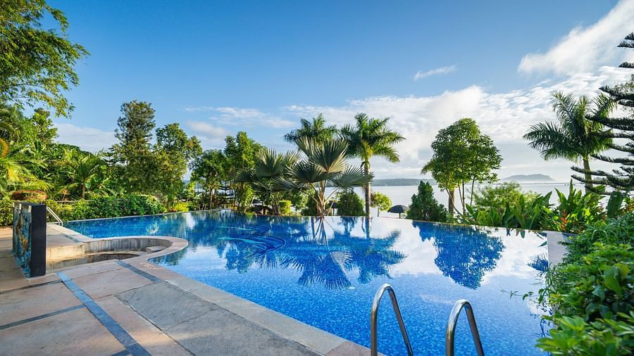 Image of a swimming pool with trees surrounding it at Coorg Jungle Camp Backwater Resort, Kushalnagar.