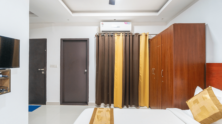 Image of a room with a bed and a wardrobe on the side at Coorg Jungle Camp Backwater Resort, Kushalnagar.