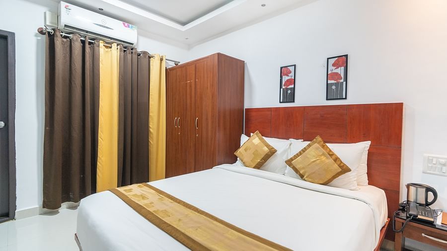 Image of a room with a bed and two photo frames above the bed at Coorg Jungle Camp Backwater Resort, Kushalnagar.