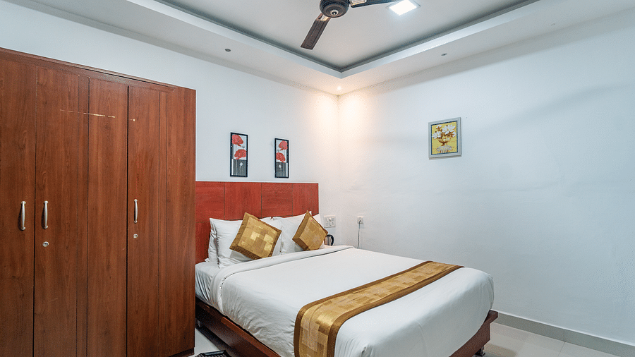 Image of a room with a bed and a wardrobe on the side at Coorg Jungle Camp Backwater Resort, Kushalnagar.