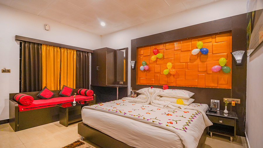 Image of a room with a bed and a seating area on the side at Coorg Jungle Camp Backwater Resort, Kushalnagar.