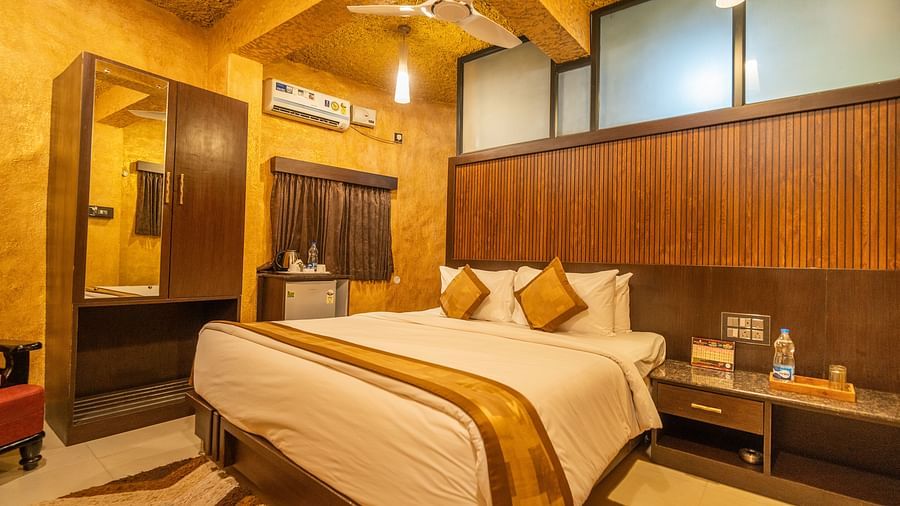Image of a room with a bed and a wardrobe on the side at Coorg Jungle Camp Backwater Resort, Kushalnagar.
