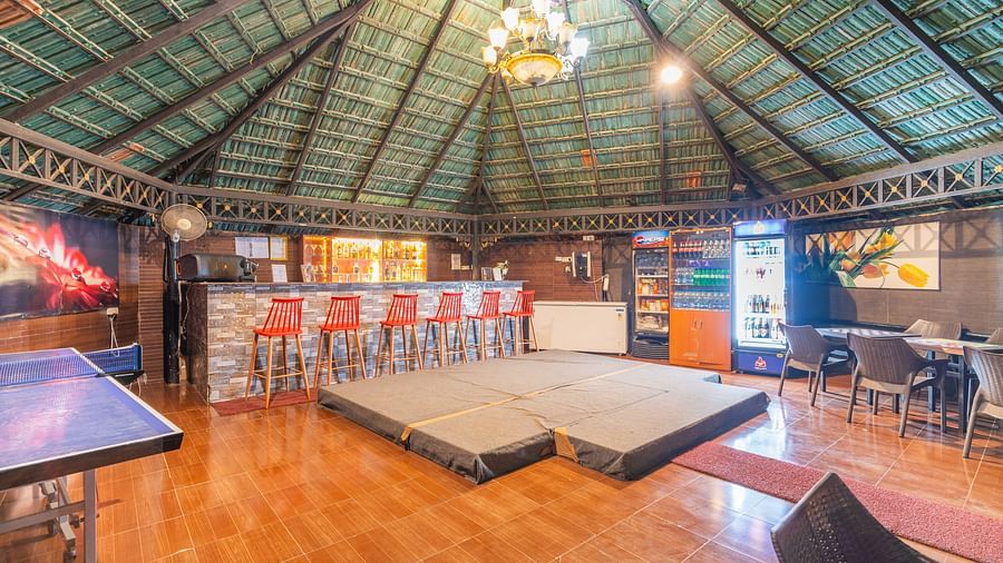 Image of a bar with chandelier on the ceiling at Coorg Jungle Camp Backwater Resort, Kushalnagar.