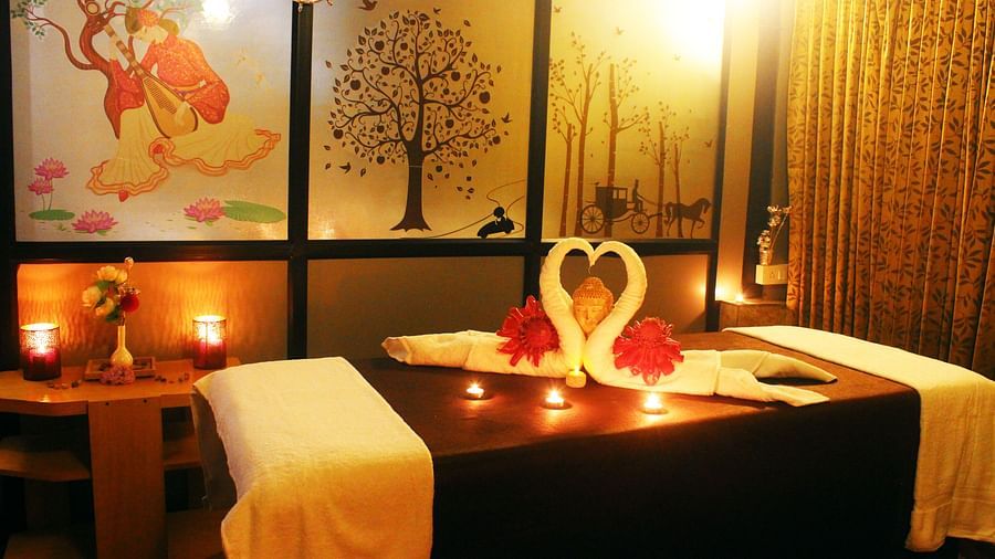 Image of a spa bed with two towel swans on it at Coorg Jungle Camp Backwater Resort, Kushalnagar.
