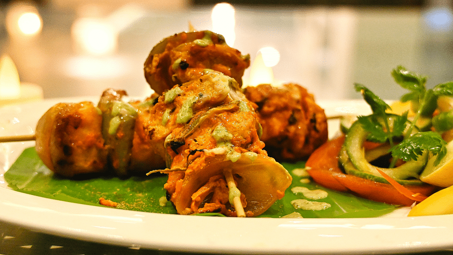 Image of a plate filled with food on skewers at Coorg Jungle Camp Backwater Resort, Kushalnagar.