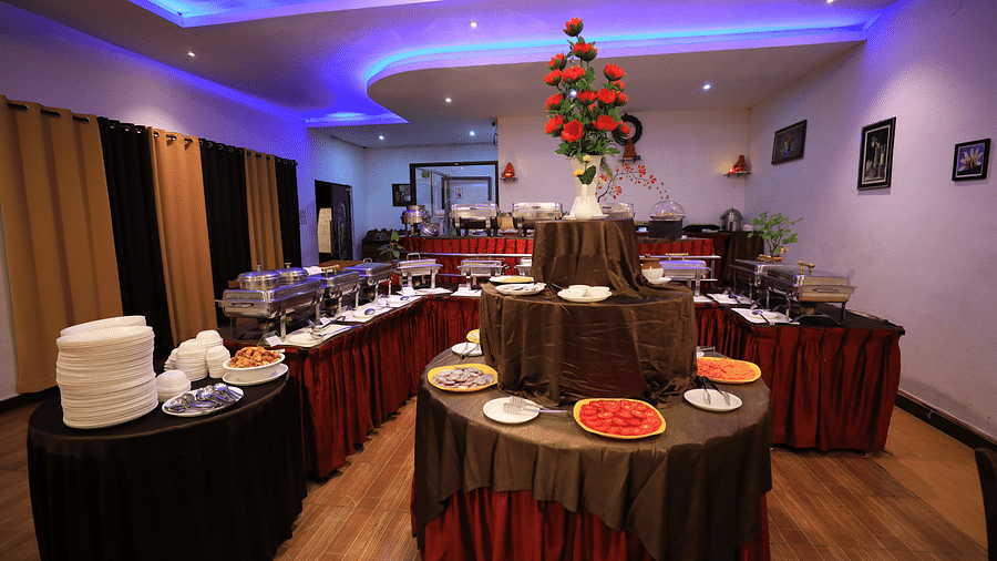 Image of a buffet table with crockery on it Coorg Jungle Camp.