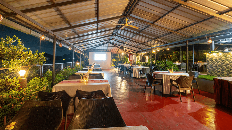 Image of a dining space with slanted roof at Coorg Jungle Camp.