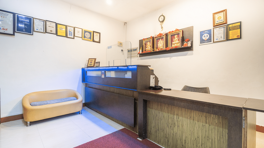 Image of a reception area with a sofa in the corner at Coorg Jungle Camp.