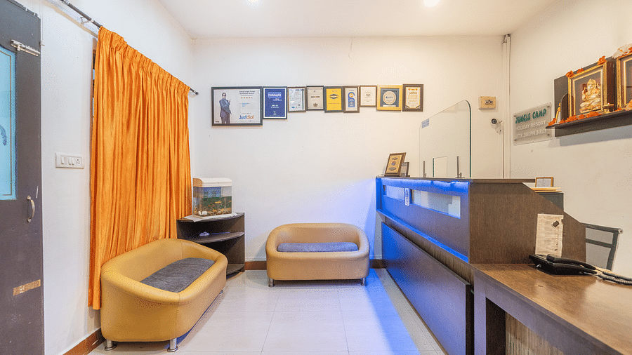 Image of a reception area with  two sofas at Coorg Jungle Camp.