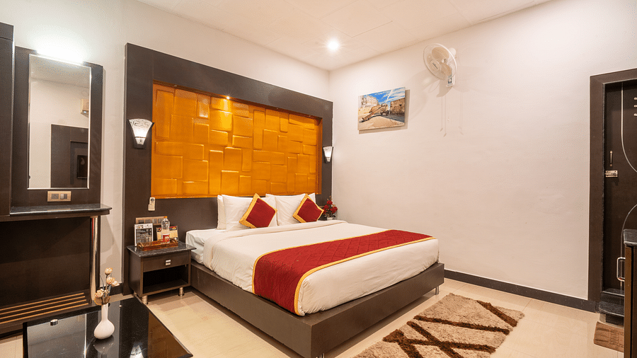 A room with a bed and a rug placed in front of it at Coorg Jungle Camp Backwater Resort, Kushalnagar.